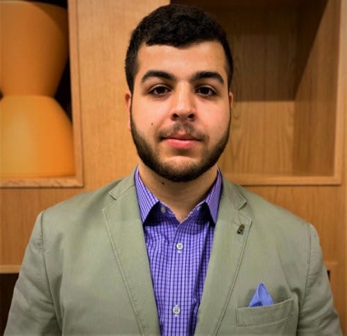 Adam Abutaa's' headshot.